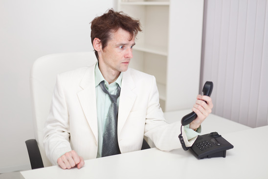 Businessman has finished difficult telephone conversation